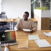 man-sitting-down-office-job-interview-desk-with-his-employers